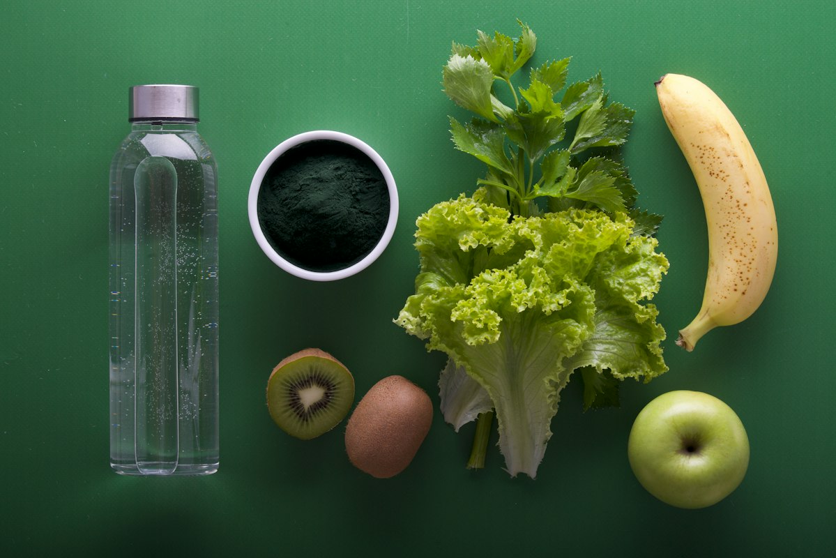 Fresh vegetables and healthy ingredients arranged on a kitchen counter